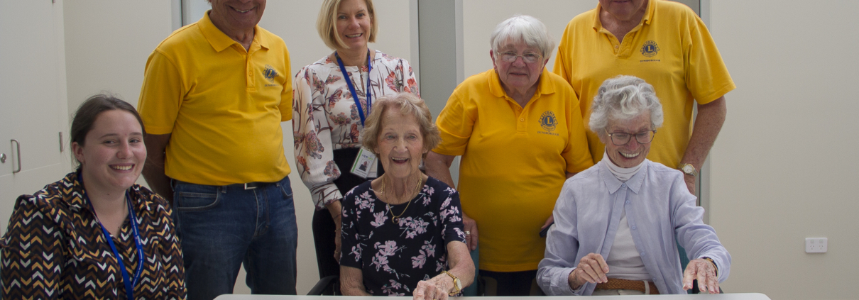A groupd of people around a table playing a game