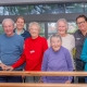 Happy Capecare clients and Allied Health staff pose for a photo in the gym