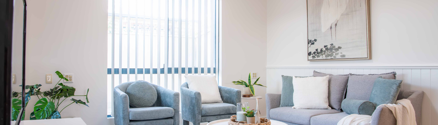 grey plush lounge chairs and white round coffee table with soft furnishings