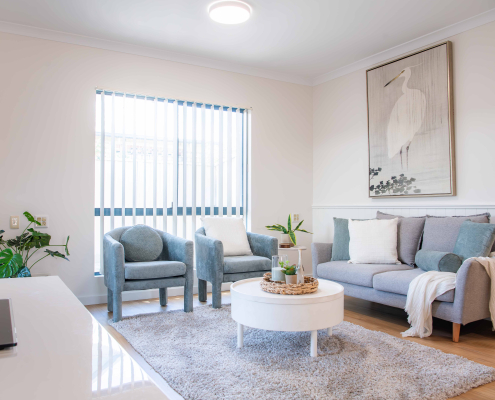 grey plush lounge chairs and white round coffee table with soft furnishings