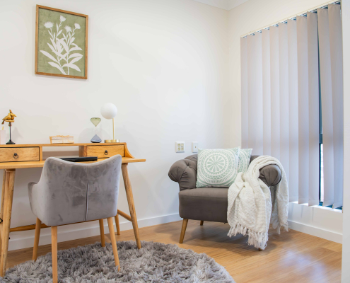 Desk and lounge chair in the study room of a retirement unit