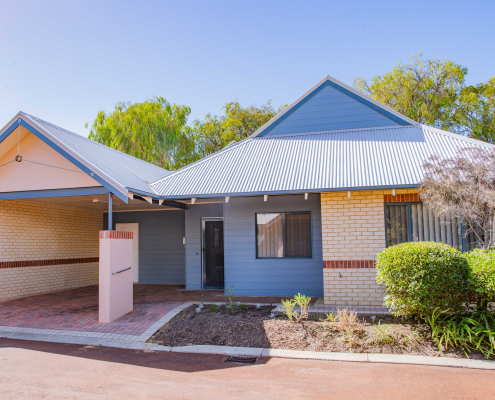 exterior view of a blue and cream single story unit