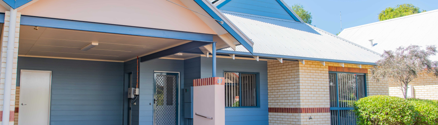 exterior view of a blue and cream single story unit