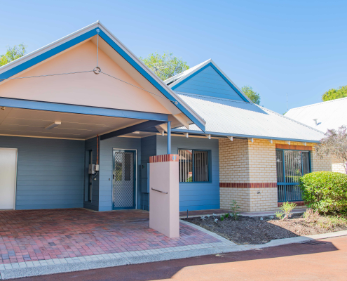 exterior view of a blue and cream single story unit