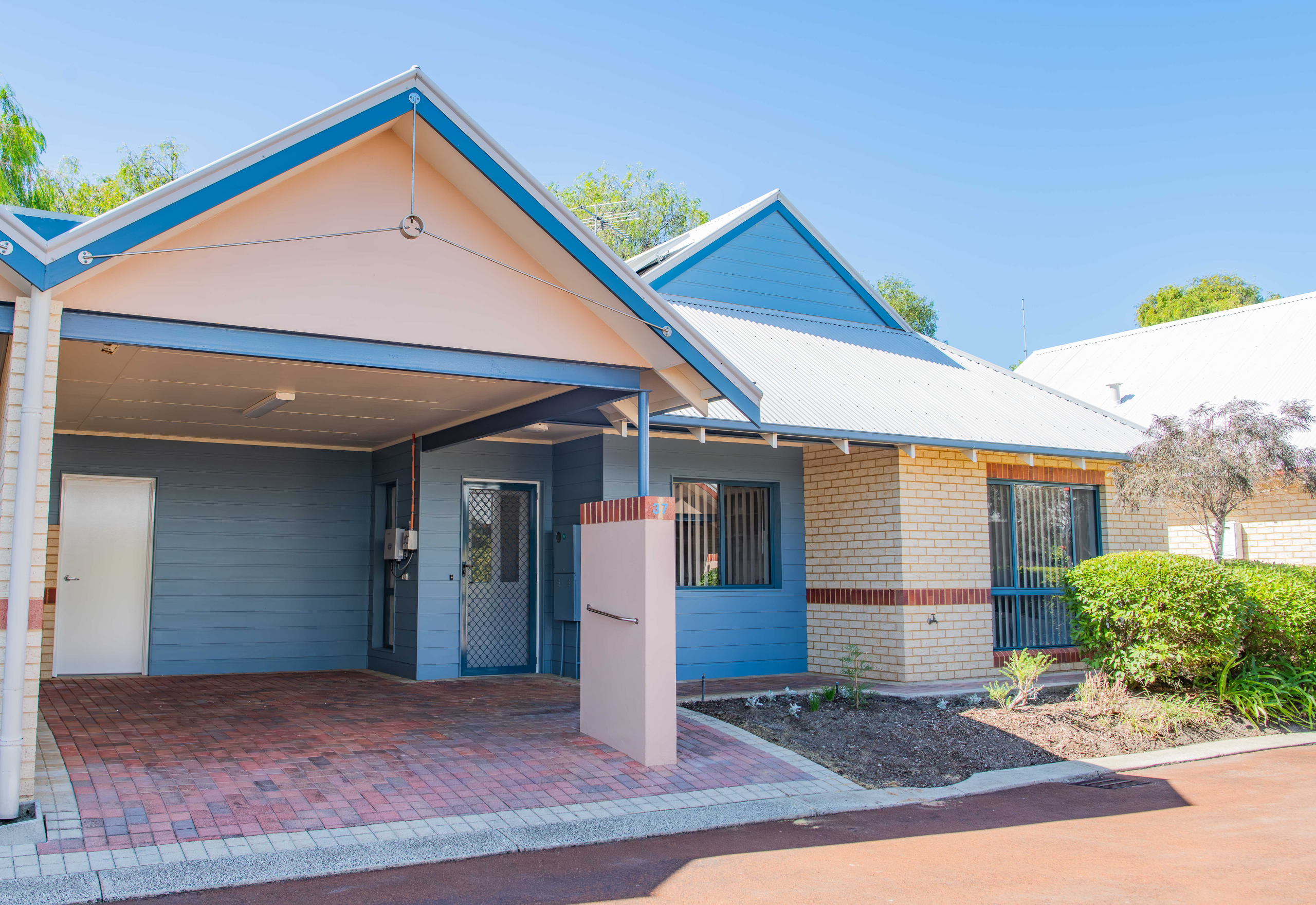 exterior view of a blue and cream single story unit