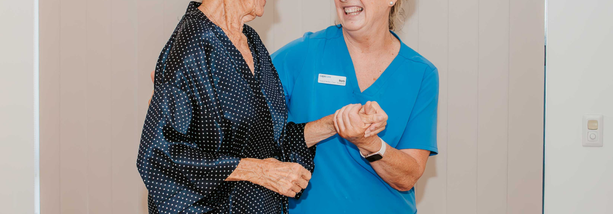 A care support worker providing personal care to an older person