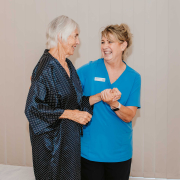 A care support worker providing personal care to an older person