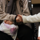 two older people holding hands